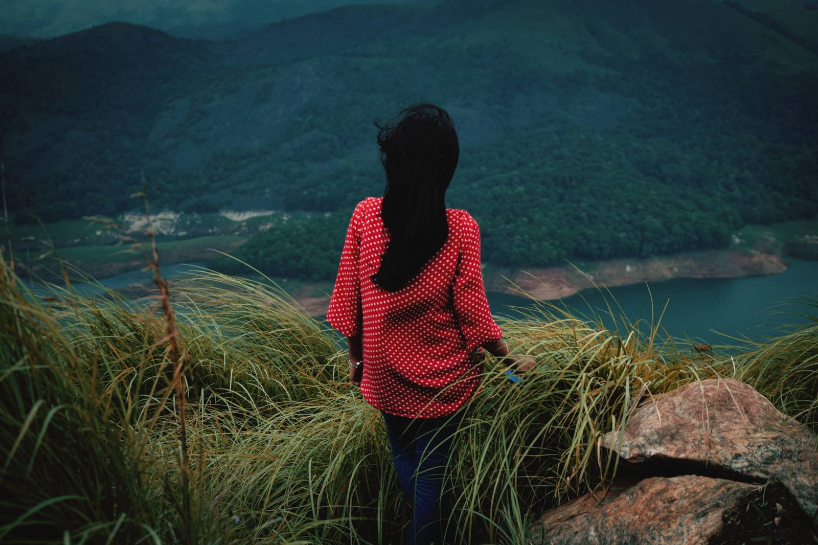 rear-view-woman-standing-mountain